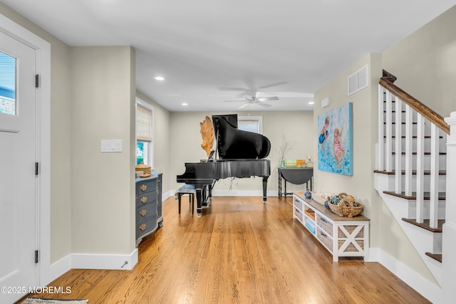 foyer entrance featuring baseboards, light wood-style floors, stairway, a ceiling fan, and recessed lighting