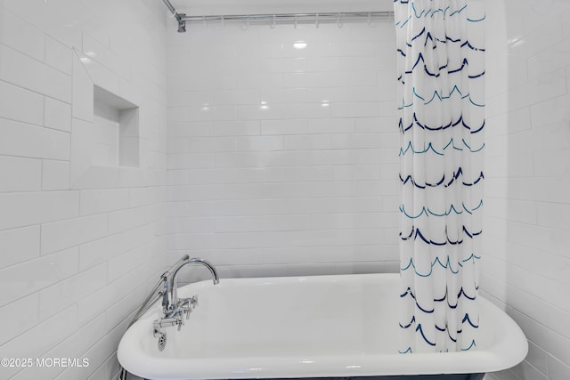 full bathroom featuring a tub, tile walls, and curtained shower