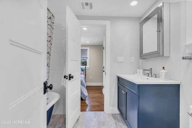 ensuite bathroom with vanity, recessed lighting, a tub, baseboards, and a shower with curtain