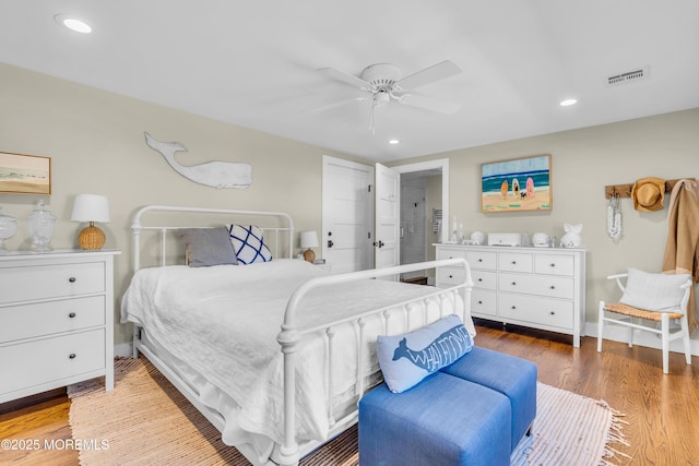 bedroom featuring wood finished floors, recessed lighting, ceiling fan, and baseboards