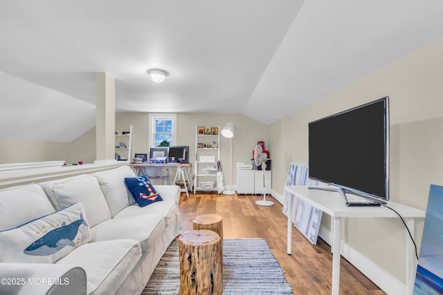 living room with lofted ceiling, wood finished floors, and baseboards