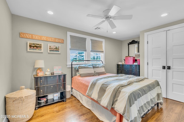 bedroom featuring wood finished floors, a closet, recessed lighting, and a ceiling fan