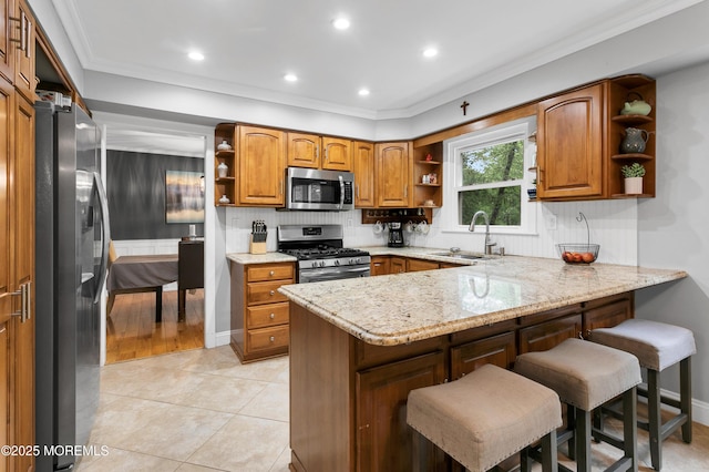 kitchen with open shelves, appliances with stainless steel finishes, a sink, a peninsula, and brown cabinets