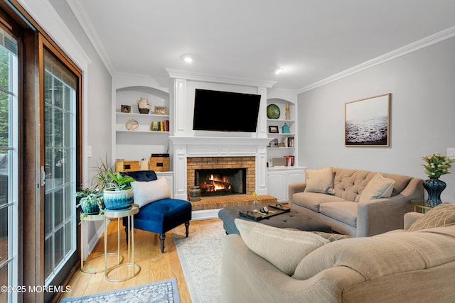 living room featuring crown molding, wood finished floors, a brick fireplace, and built in features