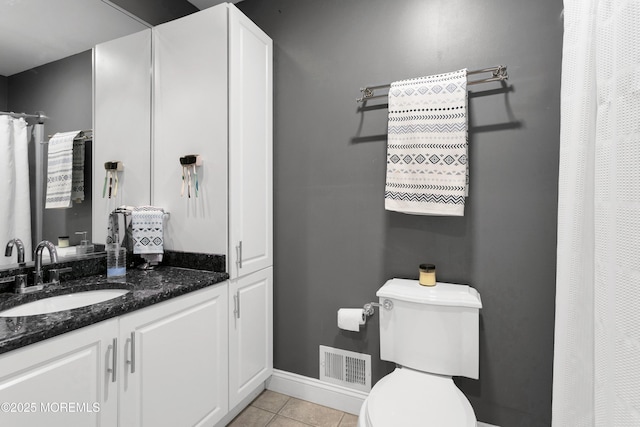 bathroom with tile patterned flooring, vanity, toilet, and baseboards