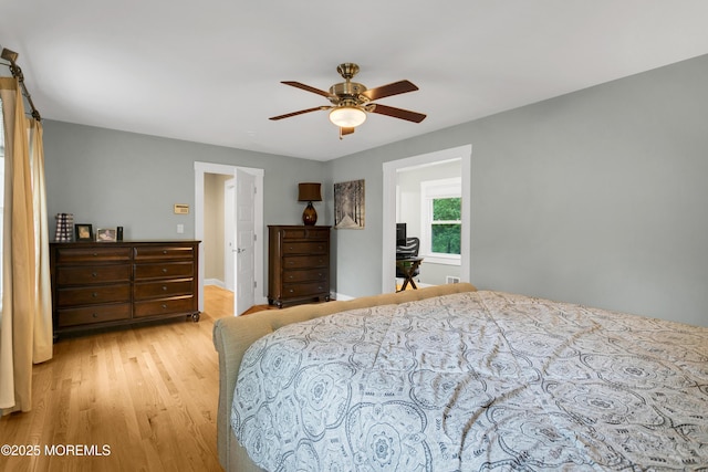 bedroom with light wood-style floors and a ceiling fan