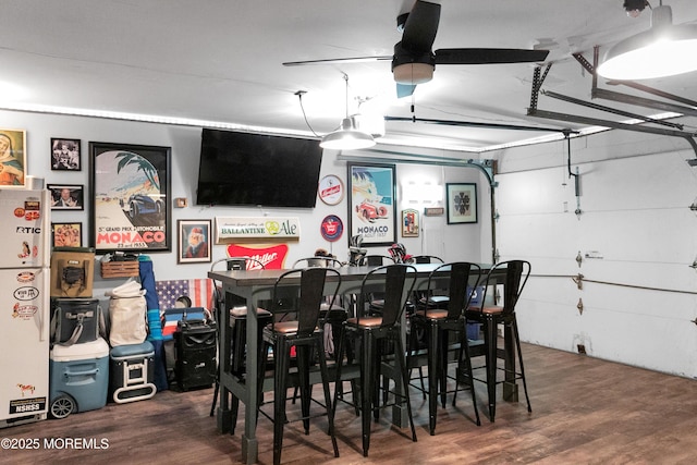 dining room with wood finished floors and ceiling fan