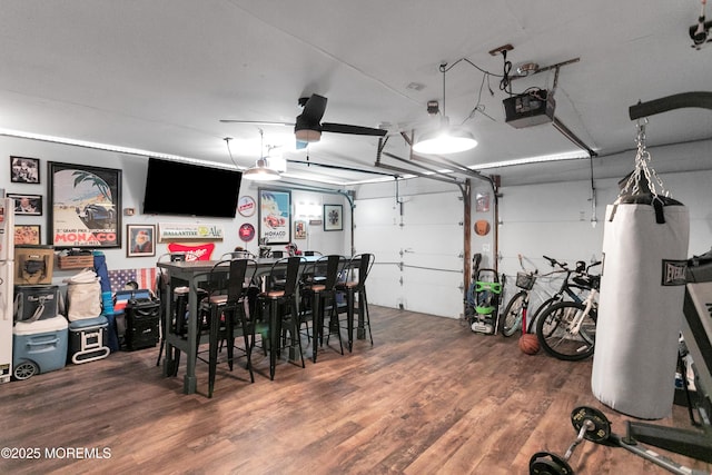 garage featuring a garage door opener and water heater