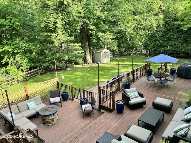 wooden deck featuring outdoor dining space, a shed, an outbuilding, a grill, and an outdoor living space with a fire pit