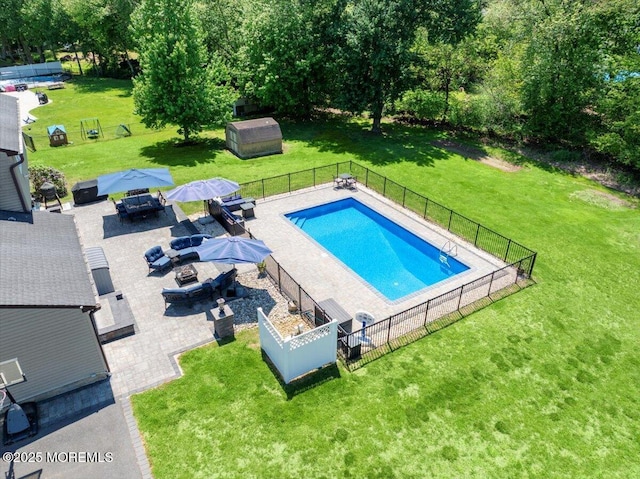 49 Glenbrook Rd, Freehold, NJ 07728 - view of swimming pool featuring an outdoor fire pit, an outdoor structure, a patio area, and a shed