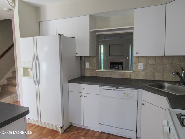 127 Meli Ln, Jackson, NJ 08527 - kitchen featuring white appliances, a sink, light wood-style flooring, and dark countertops