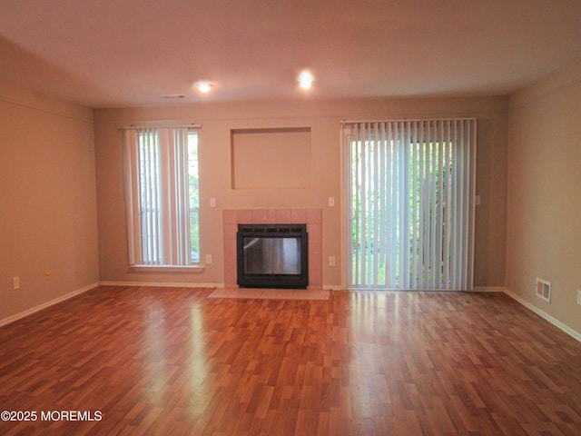 127 Meli Ln, Jackson, NJ 08527 - unfurnished living room featuring wood finished floors, a tiled fireplace, and baseboards