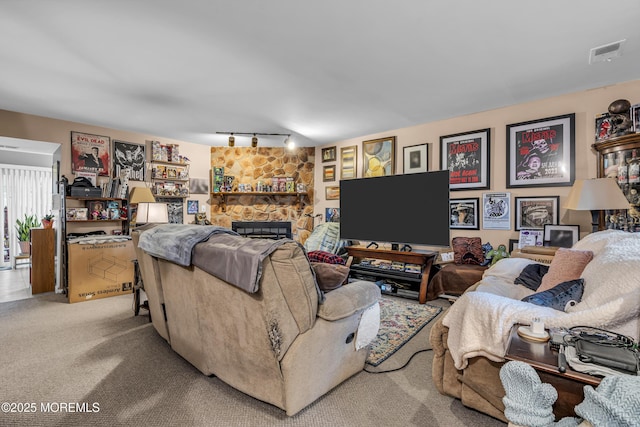 65 Creek Rd Unit 419, Brick, NJ 08724 - carpeted living room featuring rail lighting and a stone fireplace