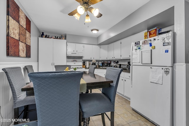 65 Creek Rd Unit 419, Brick, NJ 08724 - kitchen with white appliances, under cabinet range hood, ceiling fan, white cabinets, and light tile patterned flooring
