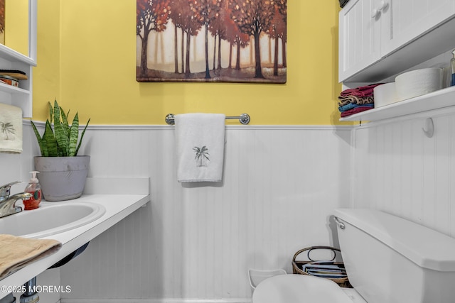65 Creek Rd Unit 419, Brick, NJ 08724 - half bath with a wainscoted wall, toilet, and a sink