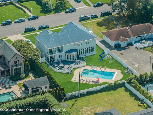 view of subject property with a pool