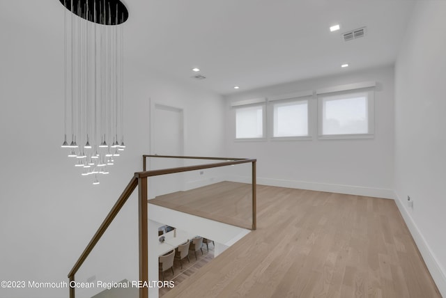 below grade area featuring light wood-type flooring, baseboards, and recessed lighting