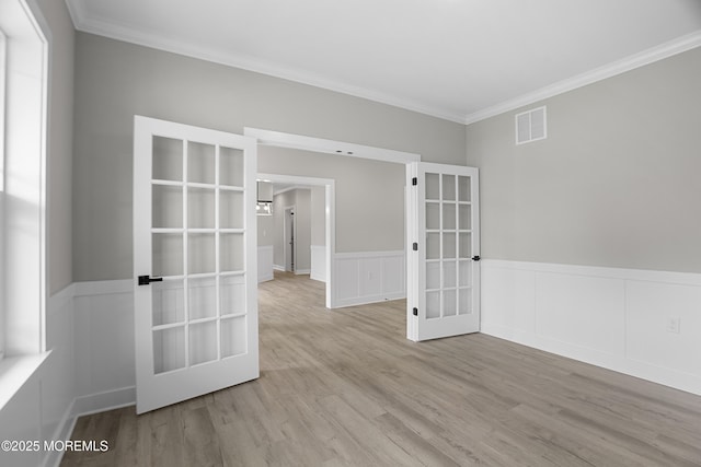1808 2nd Ave, Toms River, NJ 08757 - empty room with french doors, ornamental molding, wood finished floors, wainscoting, and a decorative wall