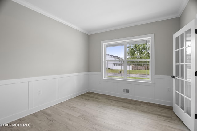1808 2nd Ave, Toms River, NJ 08757 - empty room with ornamental molding, wood finished floors, a wainscoted wall, and a decorative wall