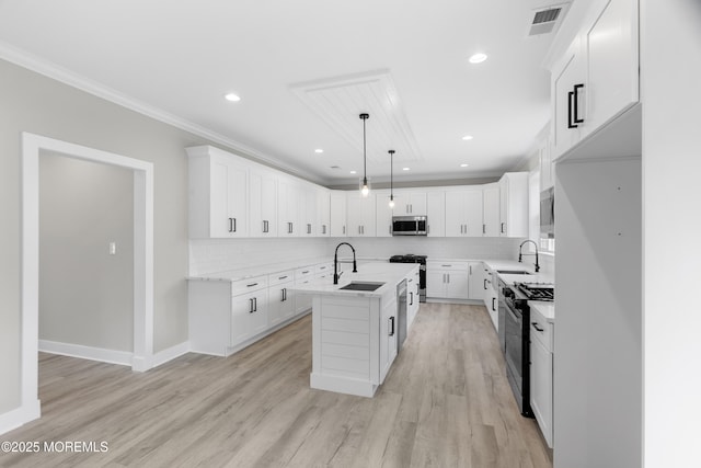 1808 2nd Ave, Toms River, NJ 08757 - kitchen featuring stainless steel appliances, a sink, a kitchen island with sink, ornamental molding, and backsplash
