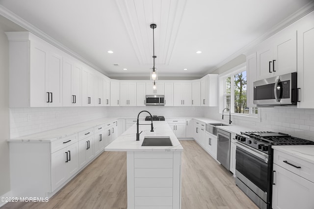 1808 2nd Ave, Toms River, NJ 08757 - kitchen with appliances with stainless steel finishes, a sink, a center island with sink, light stone countertops, and ornamental molding