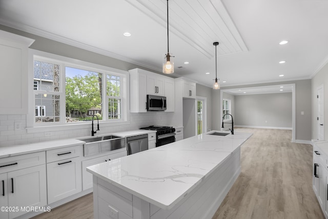 1808 2nd Ave, Toms River, NJ 08757 - kitchen with appliances with stainless steel finishes, a sink, crown molding, tasteful backsplash, and an island with sink