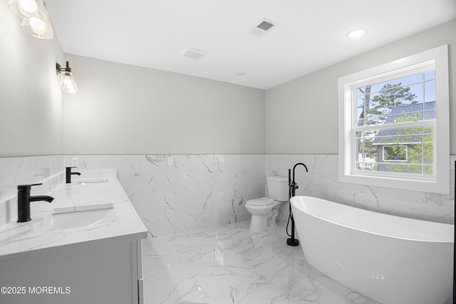 1808 2nd Ave, Toms River, NJ 08757 - bathroom featuring tile walls, a soaking tub, a wainscoted wall, marble tiled floors, and double vanity