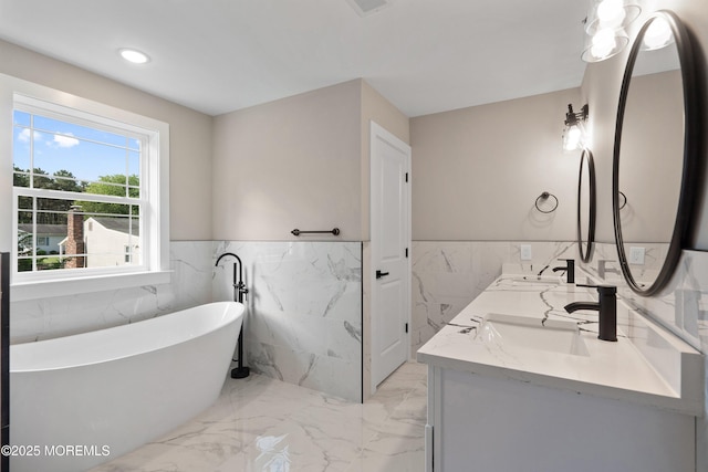 1808 2nd Ave, Toms River, NJ 08757 - bathroom with tile walls, a freestanding bath, marble tiled flooring, double vanity, and a wainscoted wall