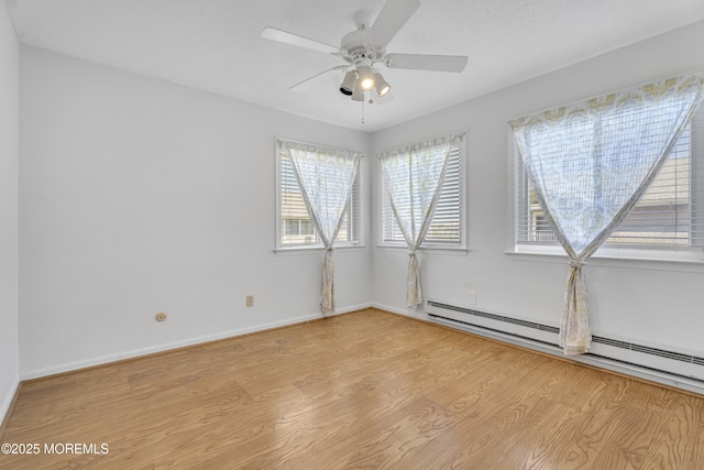 50 Valentine St Unit 14B, Monmouth Beach, NJ 07750 - empty room featuring baseboard heating, light wood-style flooring, healthy amount of natural light, and ceiling fan