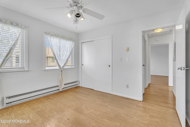50 Valentine St Unit 14B, Monmouth Beach, NJ 07750 - unfurnished bedroom featuring a baseboard heating unit, light wood-style flooring, a closet, and a ceiling fan