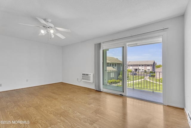 50 Valentine St Unit 14B, Monmouth Beach, NJ 07750 - spare room with an AC wall unit, wood finished floors, a textured ceiling, a ceiling fan, and a baseboard heating unit
