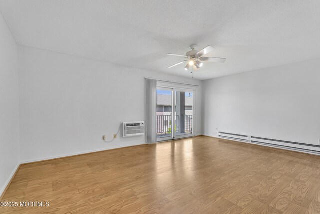 50 Valentine St Unit 14B, Monmouth Beach, NJ 07750 - empty room featuring a wall unit AC, ceiling fan, wood finished floors, baseboard heating, and baseboards
