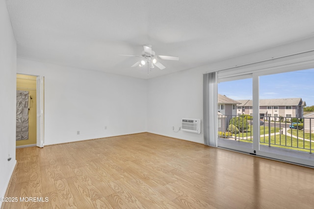 50 Valentine St Unit 14B, Monmouth Beach, NJ 07750 - empty room featuring healthy amount of natural light, light wood-style flooring, ceiling fan, and a wall unit AC