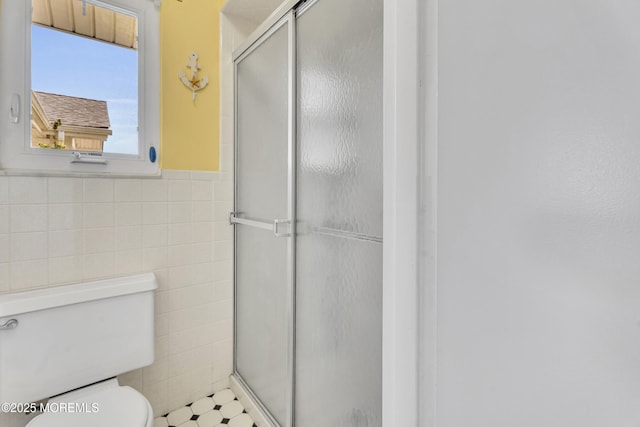 50 Valentine St Unit 14B, Monmouth Beach, NJ 07750 - full bath featuring tile walls, toilet, a stall shower, and wainscoting