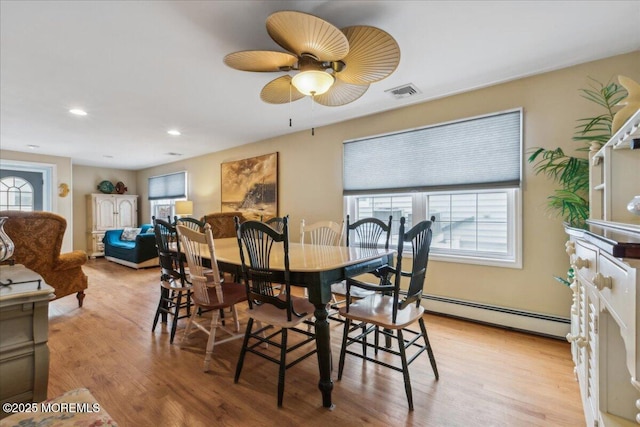 dining space with a baseboard heating unit, plenty of natural light, a ceiling fan, and recessed lighting
