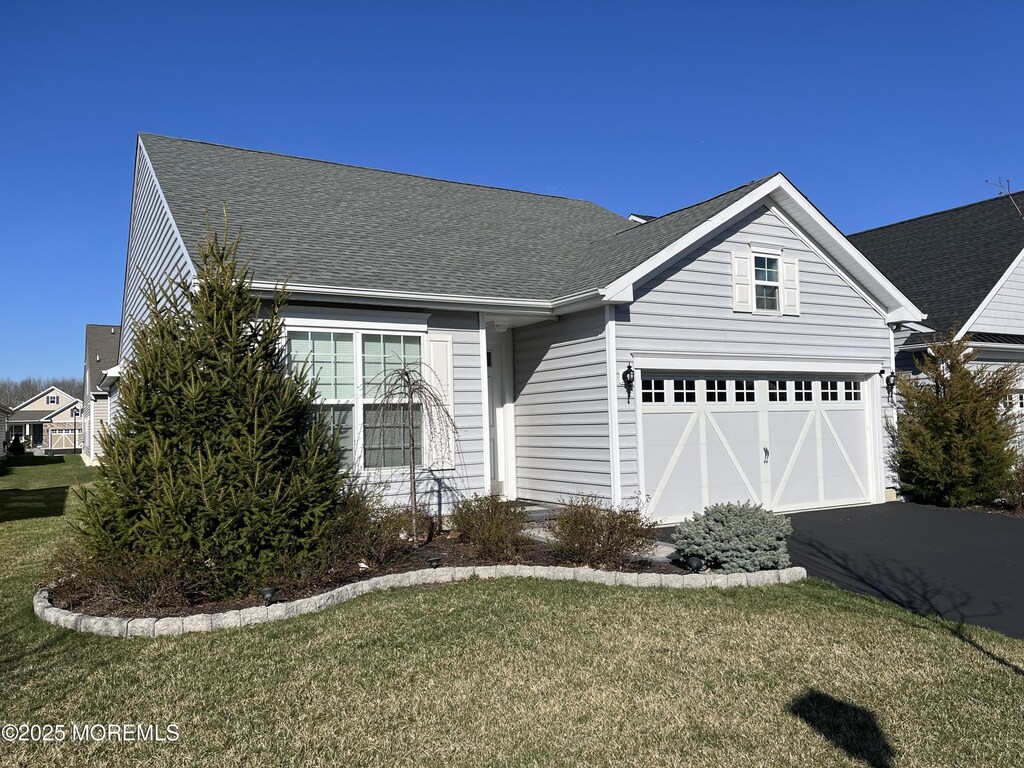 10 Moonlight Way, Howell, NJ 07731 - view of front facade featuring asphalt driveway, a front yard, and roof with shingles