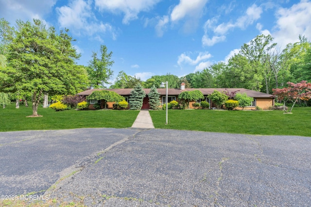 ranch-style home with a front lawn