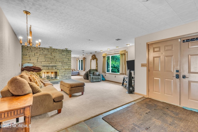 carpeted living area with a chandelier and a stone fireplace