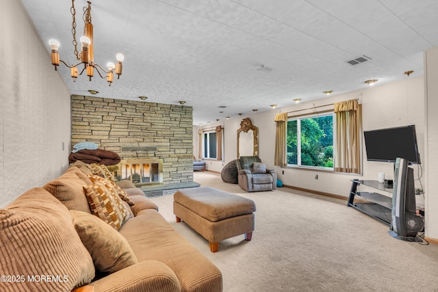 living area featuring carpet flooring, a chandelier, a fireplace, and baseboards