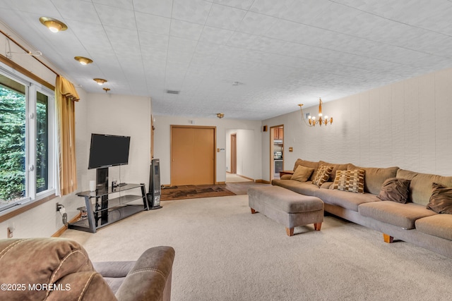 living area featuring carpet floors and a chandelier