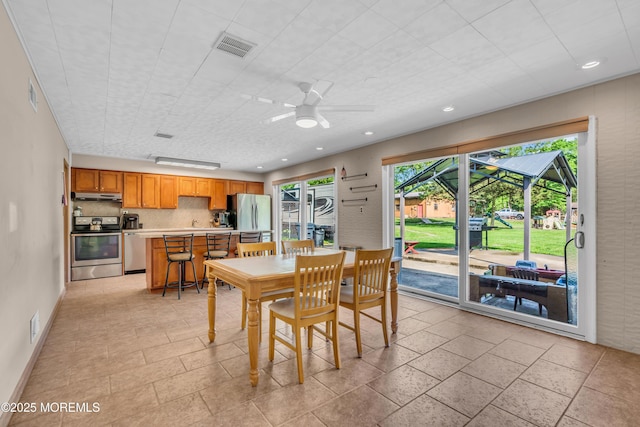 dining room with ceiling fan, recessed lighting, and baseboards