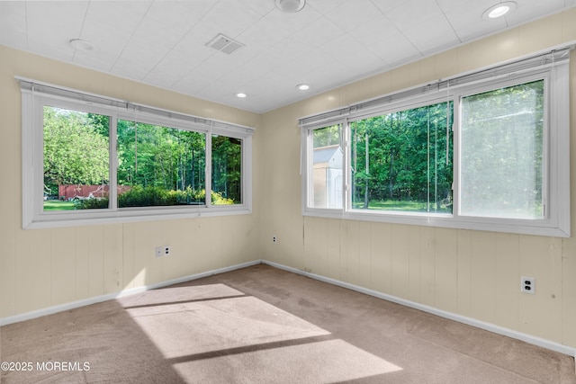 unfurnished room with carpet and baseboards