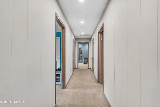 hallway with light colored carpet, recessed lighting, and baseboards