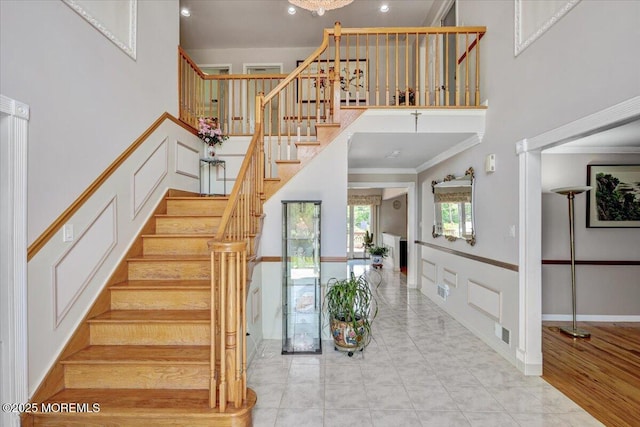 48 Joseph St, Manalapan, NJ 07726 - stairway featuring a towering ceiling and crown molding