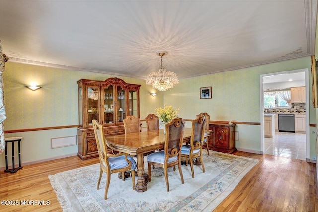 48 Joseph St, Manalapan, NJ 07726 - dining space featuring a chandelier, light wood-style floors, and ornamental molding
