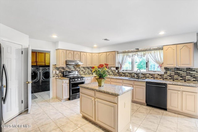 48 Joseph St, Manalapan, NJ 07726 - kitchen featuring range with two ovens, black dishwasher, washer and dryer, a sink, and under cabinet range hood