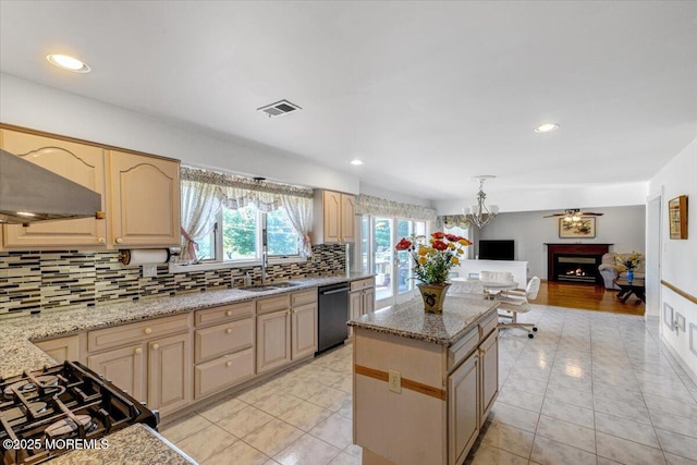 48 Joseph St, Manalapan, NJ 07726 - kitchen featuring black appliances, a sink, decorative backsplash, a kitchen island, and a lit fireplace