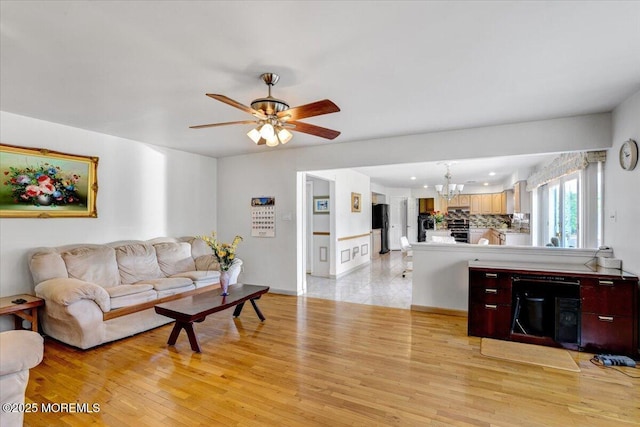 48 Joseph St, Manalapan, NJ 07726 - living room featuring a chandelier, light wood-style flooring, and ceiling fan