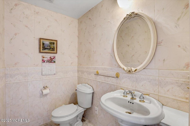 48 Joseph St, Manalapan, NJ 07726 - bathroom featuring a sink, toilet, a wainscoted wall, and tile walls