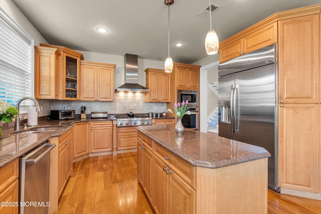 11 Aspen Ln, Tinton Falls, NJ 07724 - kitchen featuring built in appliances, wall chimney exhaust hood, a sink, a kitchen island, and glass insert cabinets